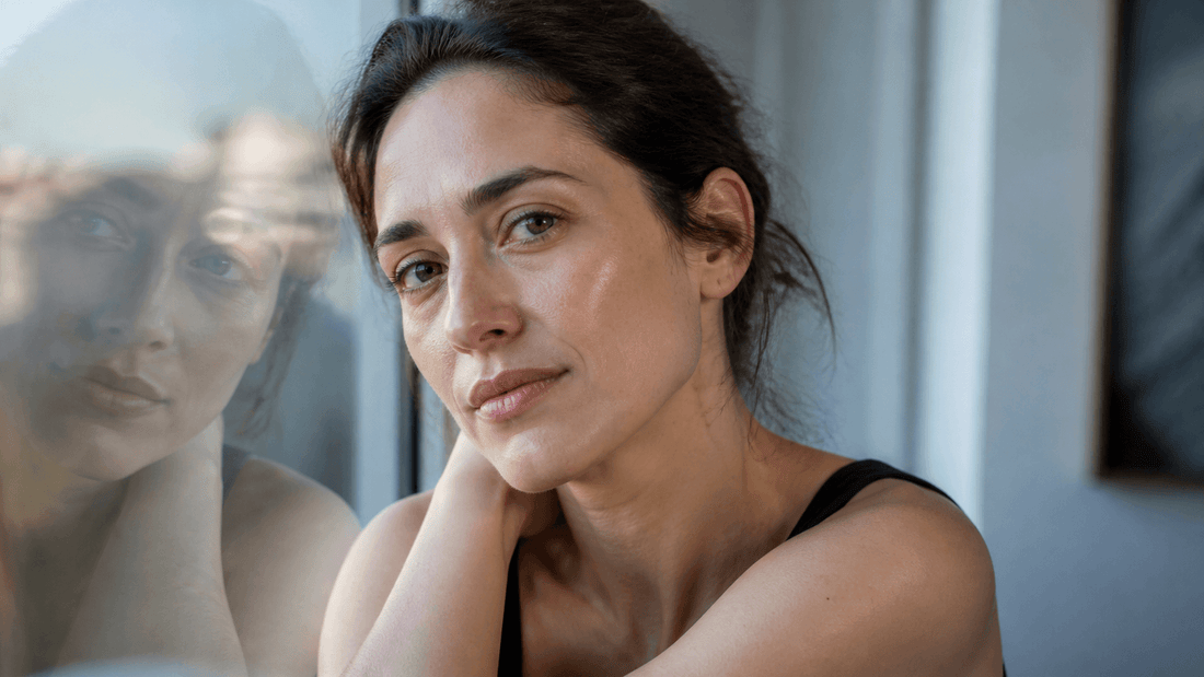 Close editorial portrait showing natural under-eye shadows in soft daylight