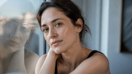Close editorial portrait showing natural under-eye shadows in soft daylight