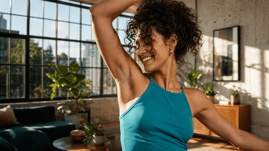 Confident woman raising her arm in a bright modern studio