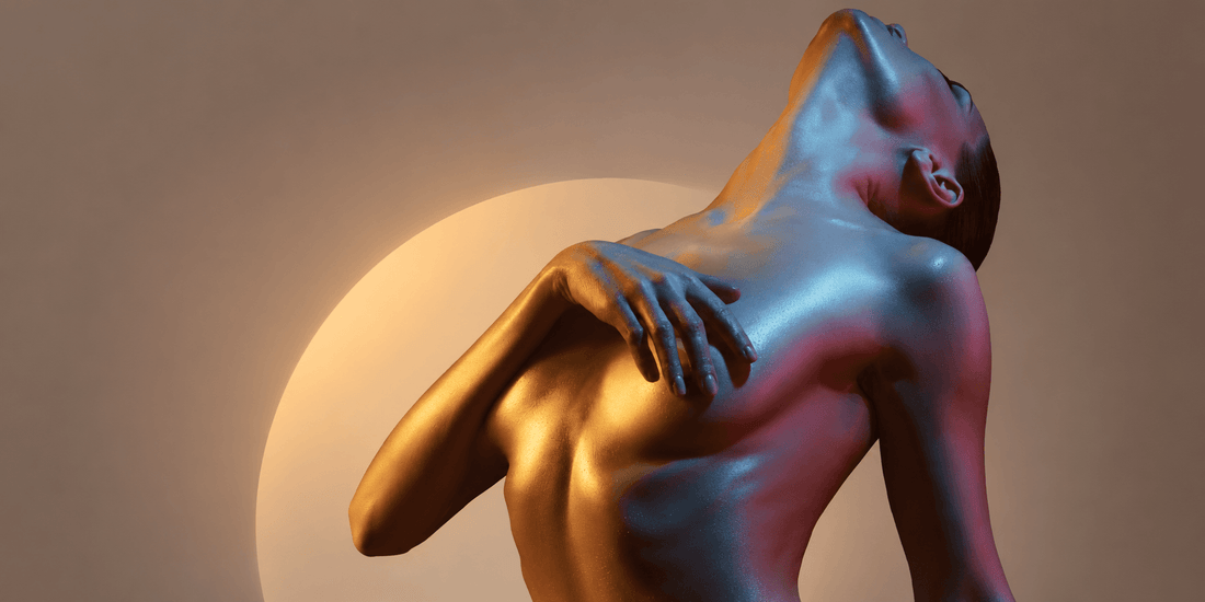 Natural light and a glass prism casting color across an adult arm